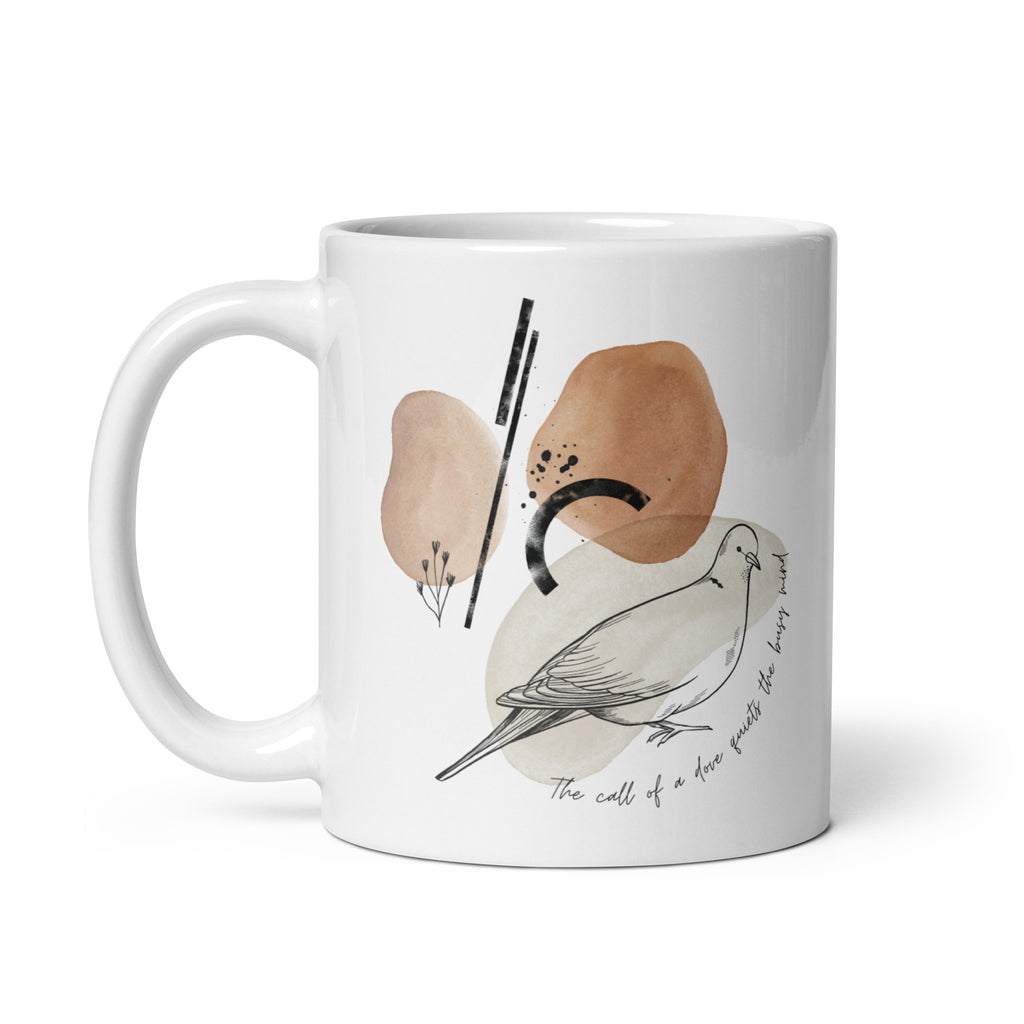 White 11 ounce ceramic mug featuring a sketch of a morning dove against a background of abstract shapes in neutral earth tone colors.